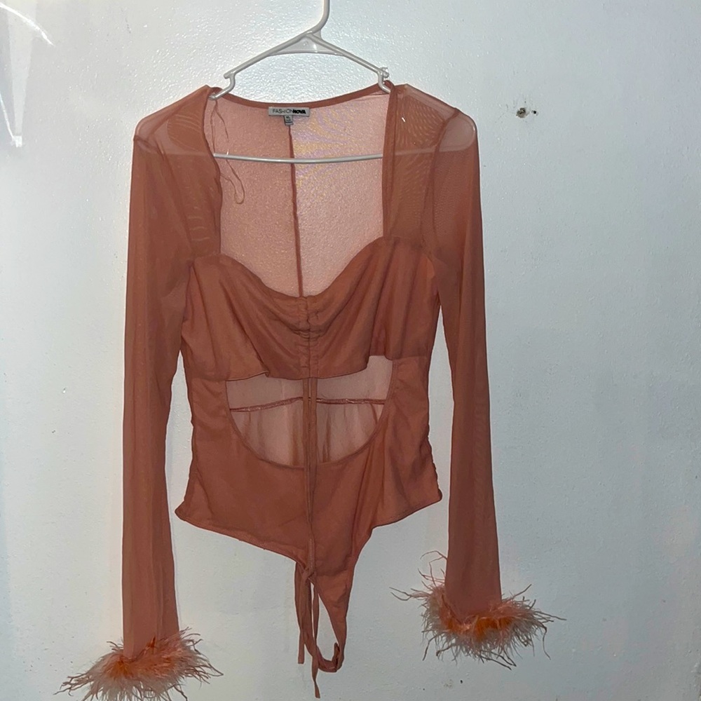 XL blush body suit with feathers on bottom of each sleeve